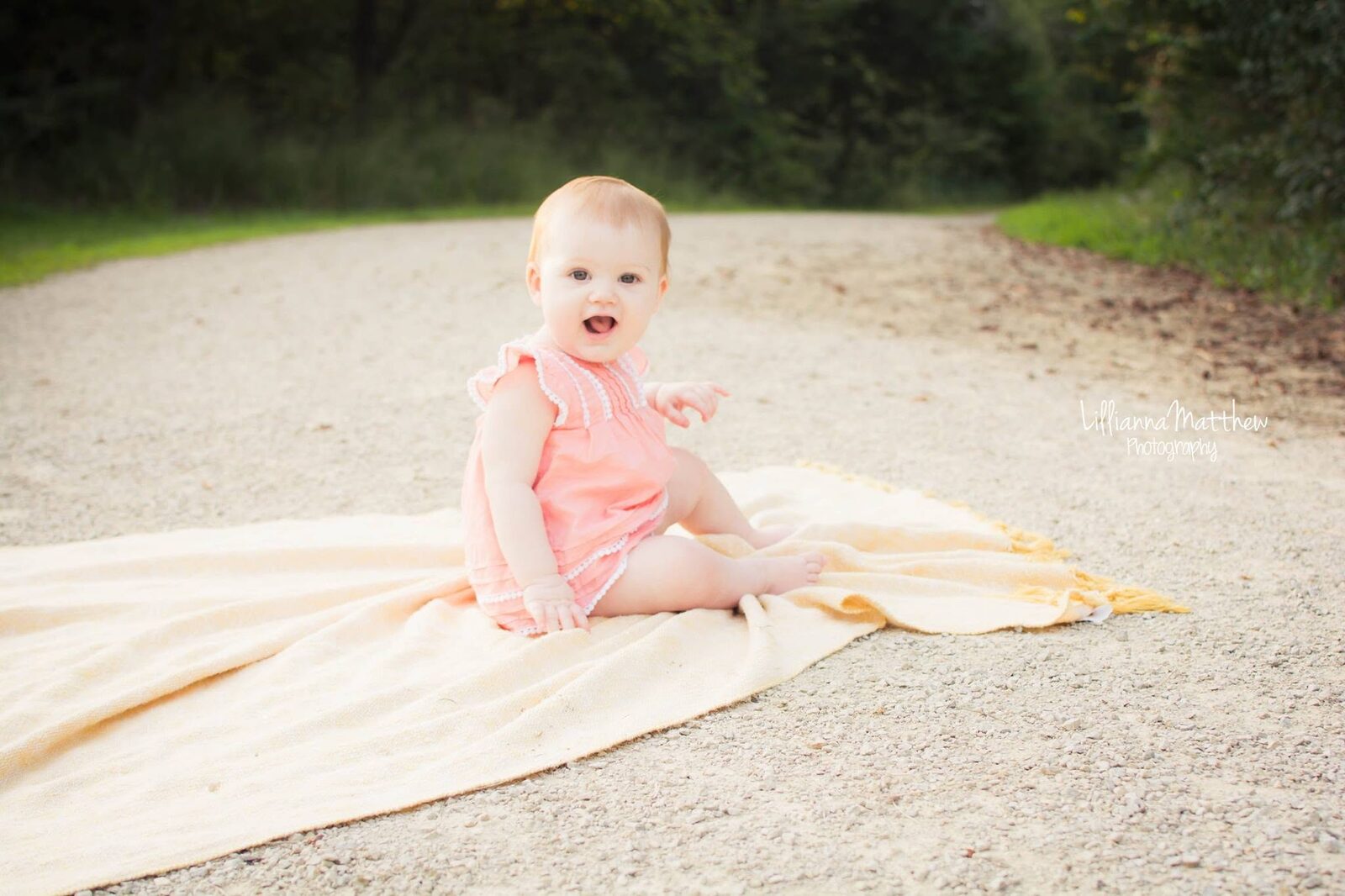 Baby with an animated, laughing expression on a blanket