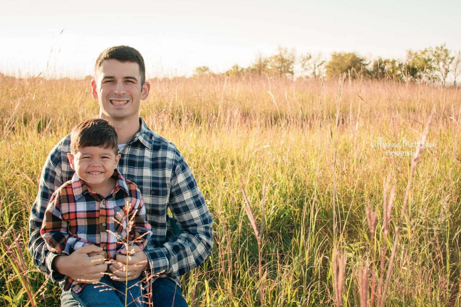 Father and son close portrait, both smiling genuinely