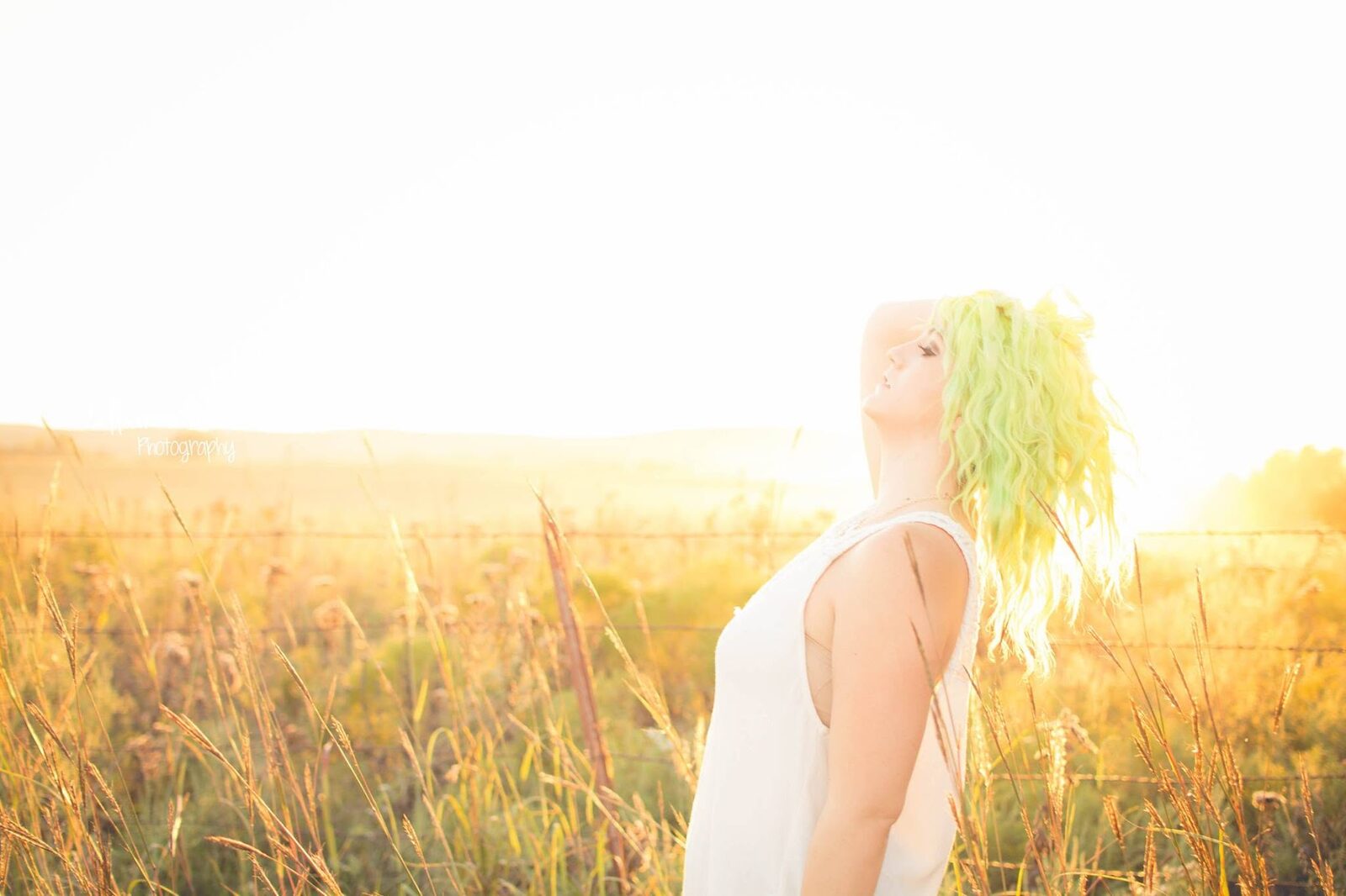 Golden-hour, ethereal side profile portrait in a wheat field
