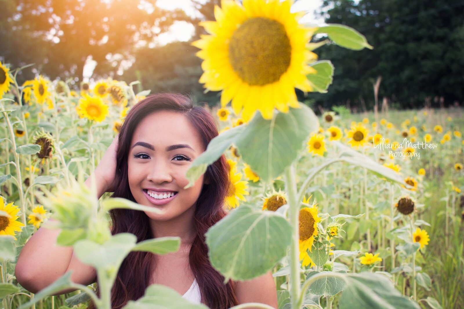 Bright smile framed by sunflowers