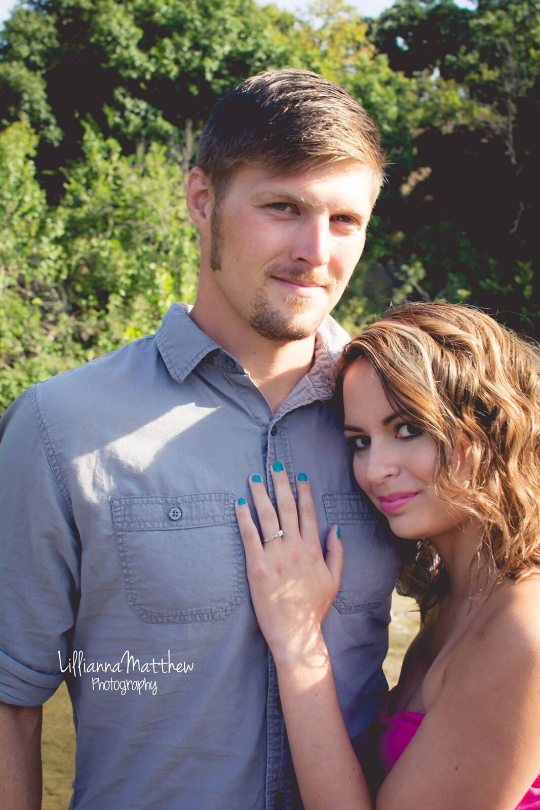Close couple portrait showing off the engagement ring