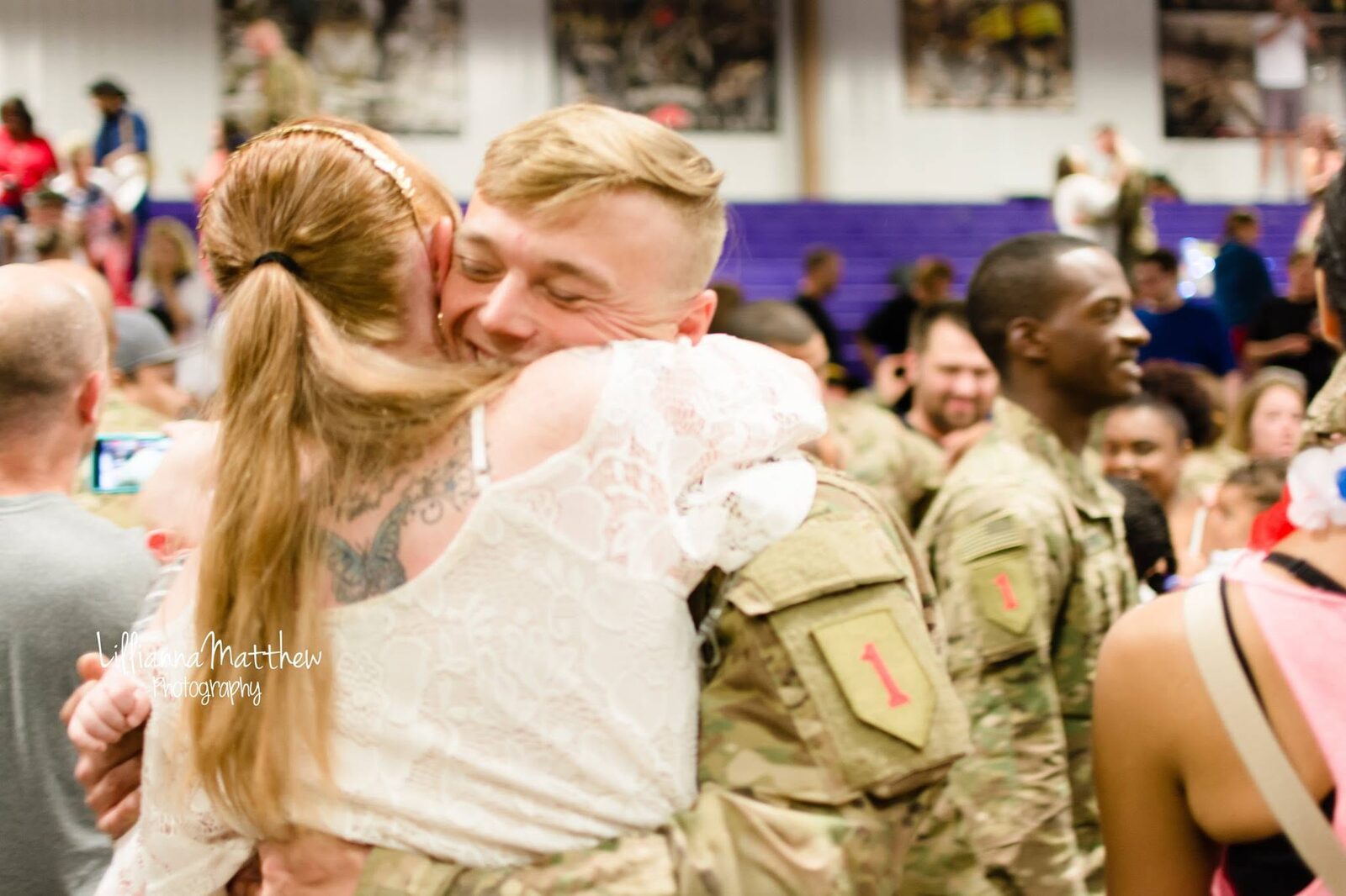 Soldier's genuinely joyful expression during an embrace with his wife, close crop