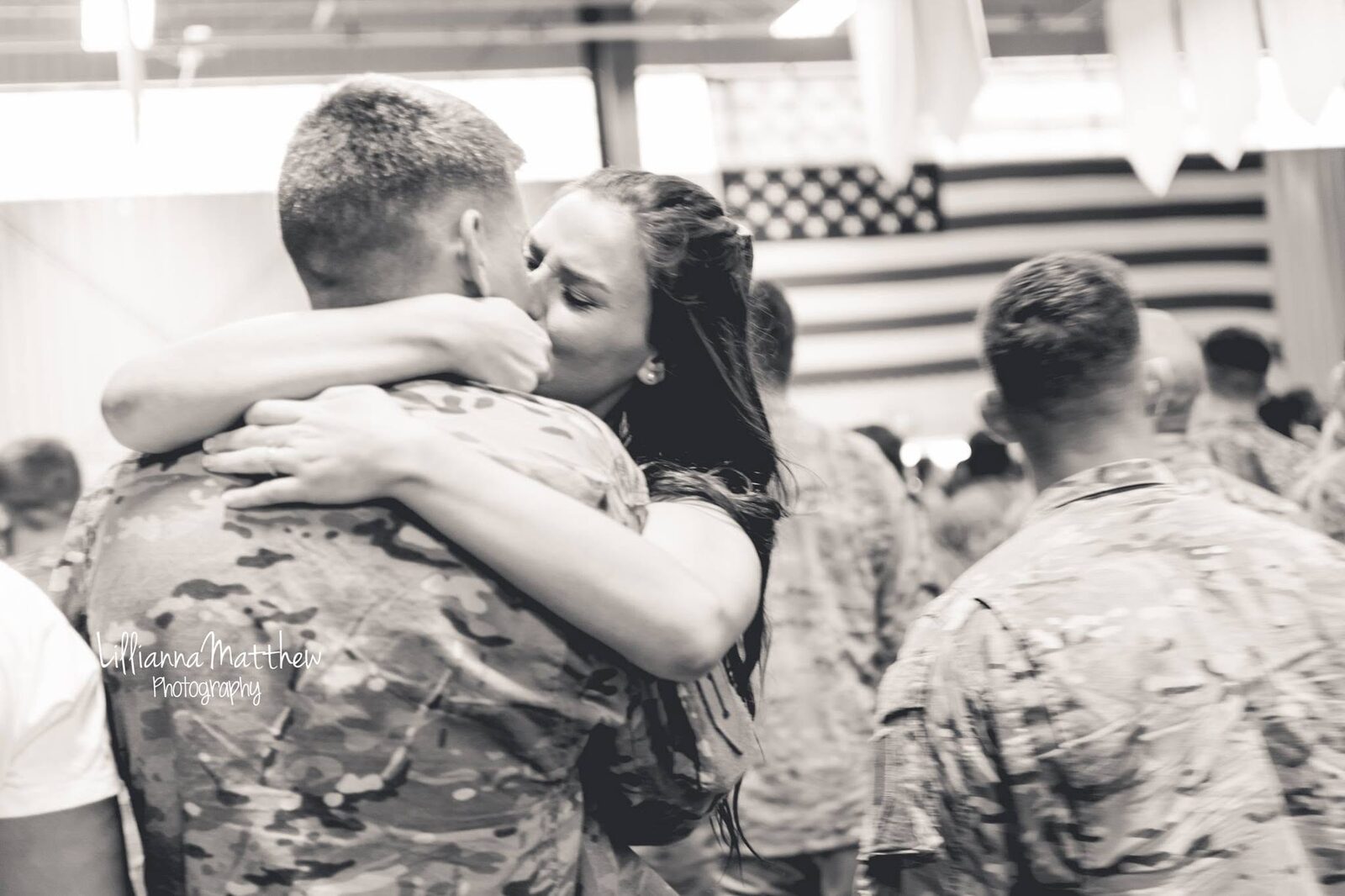 Black and white version of the same reunion, a tender cheek kiss