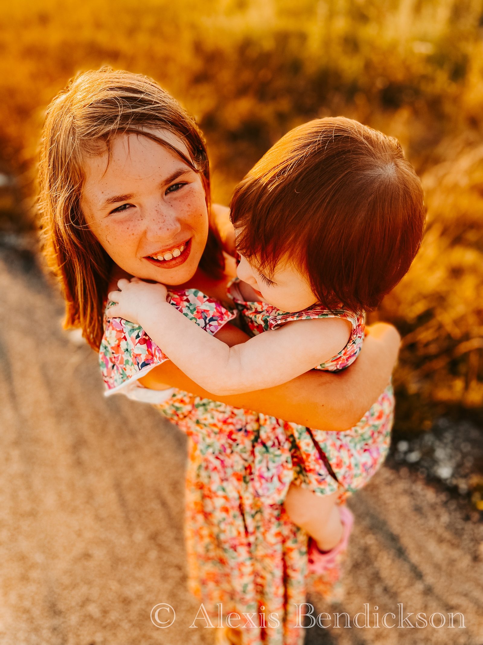 Overhead portrait of Arianna holding Emme close at golden hour