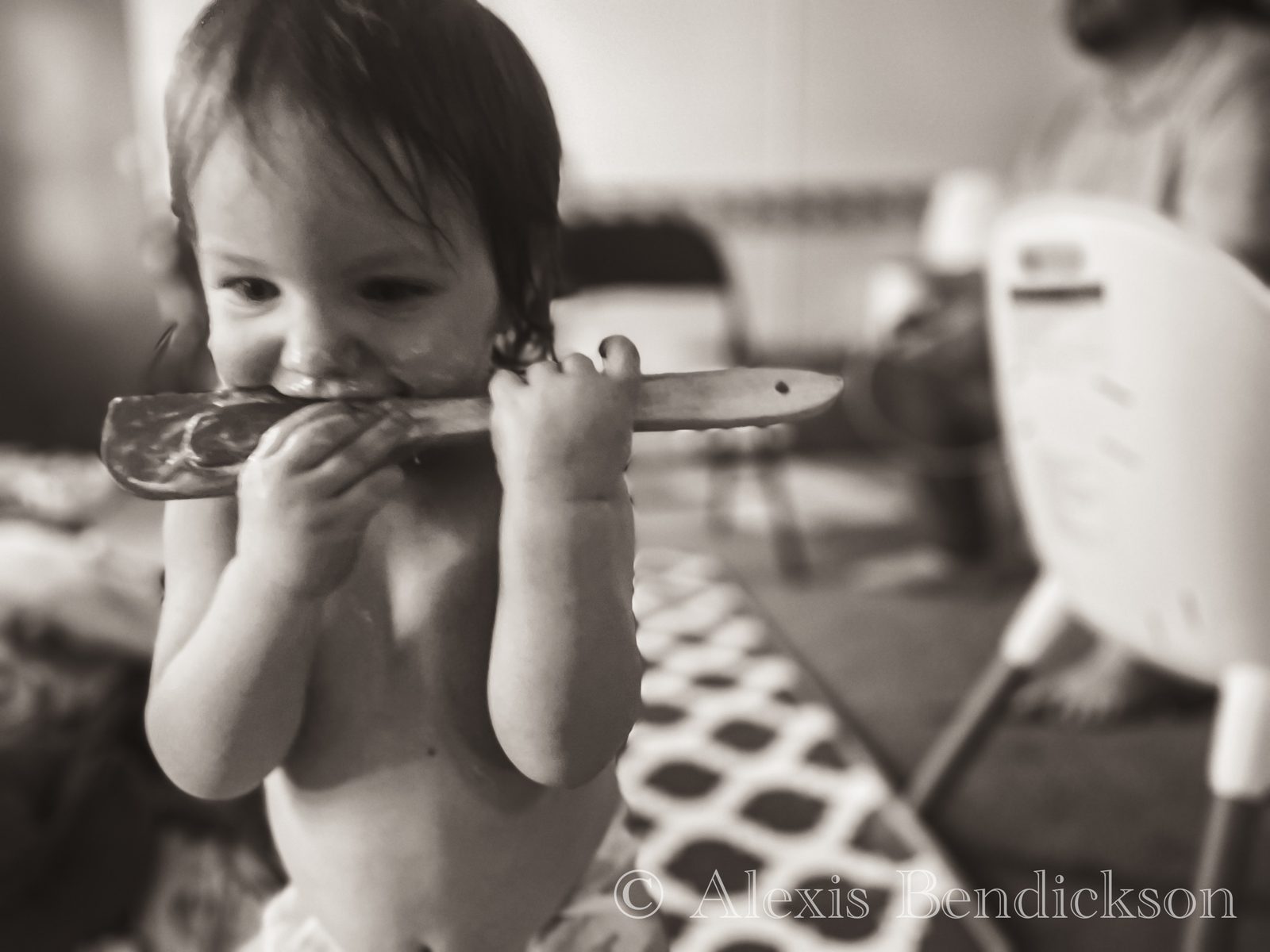 Close-up of Emme biting a spatula, black and white