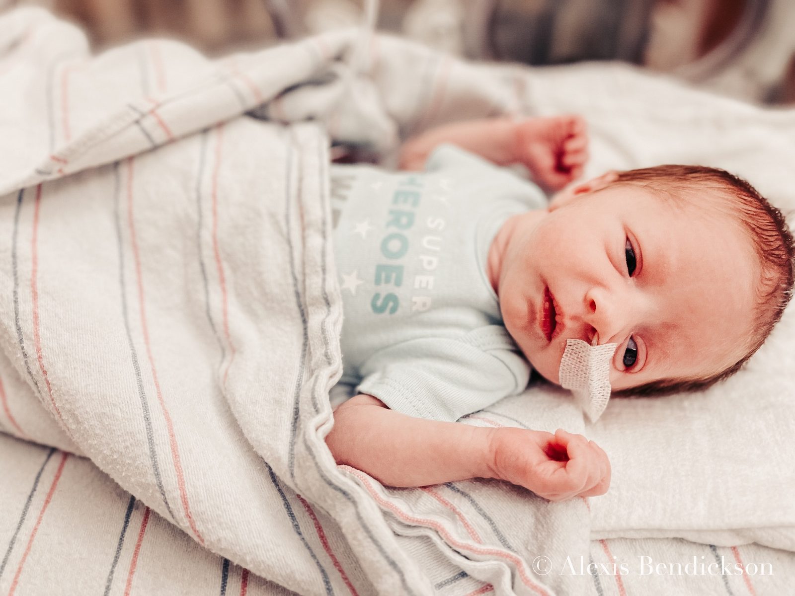 Newborn Emme in the NICU, hand near her face, February 2022