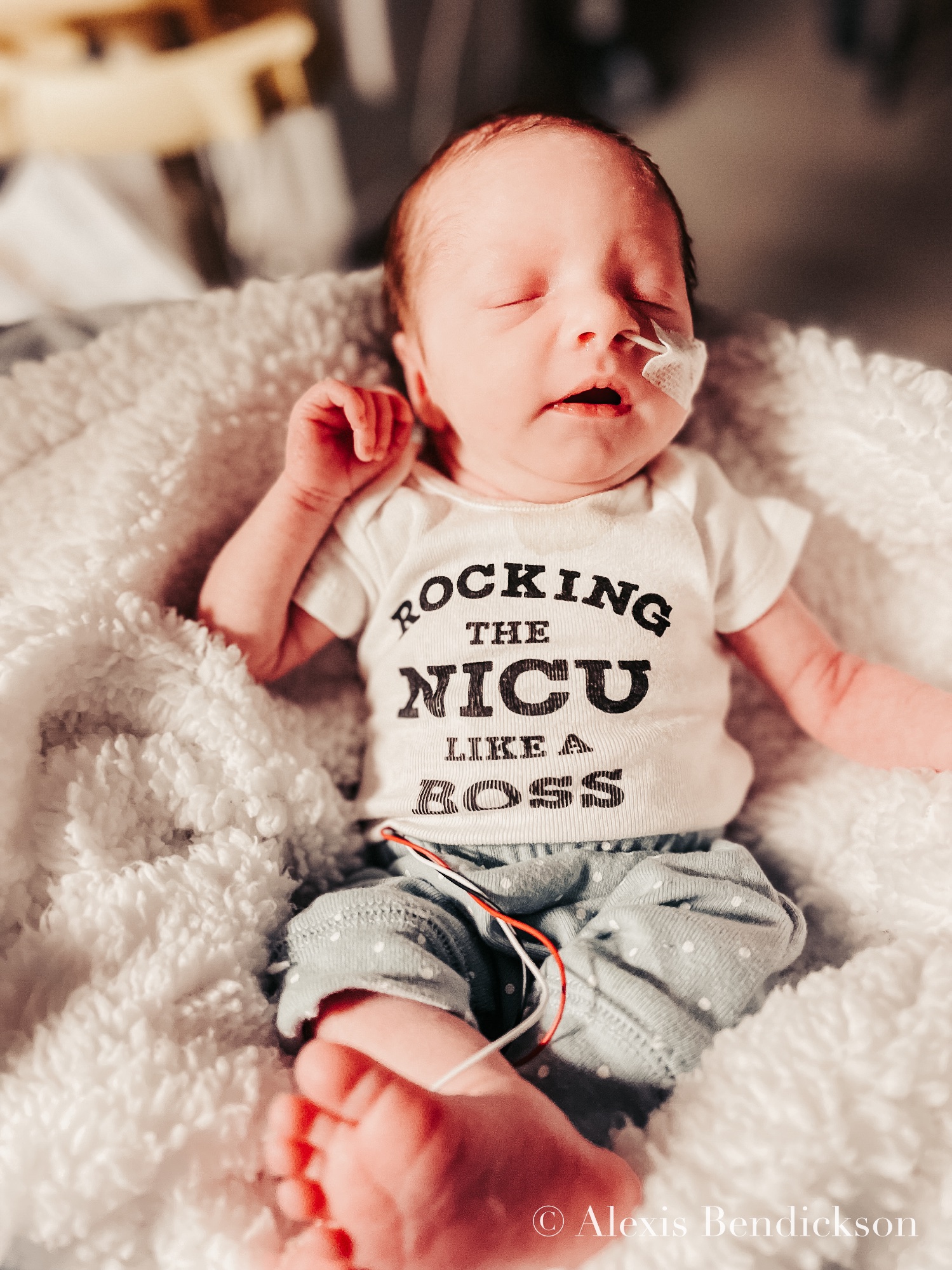 Emme sleeping in a 'rocking the NICU like a boss' onesie, February 2022