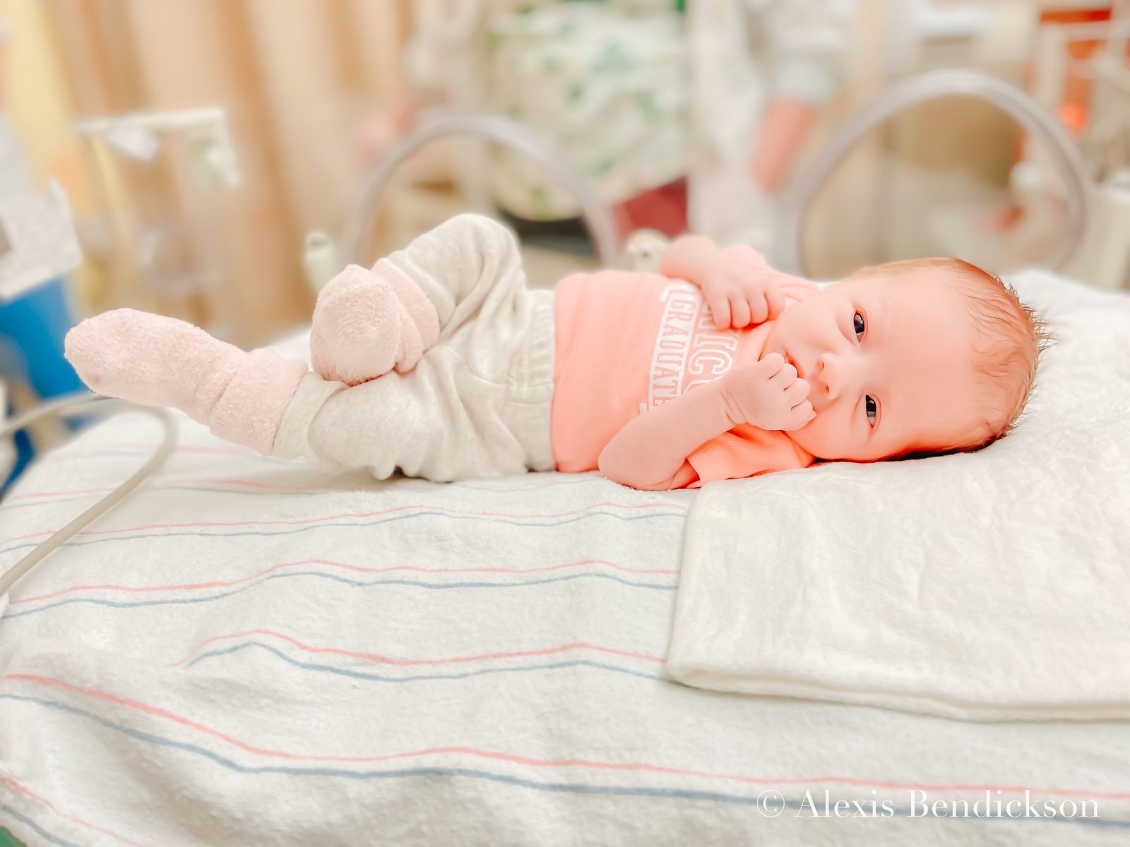 Emme in a 'NICU graduate' onesie, February 2022